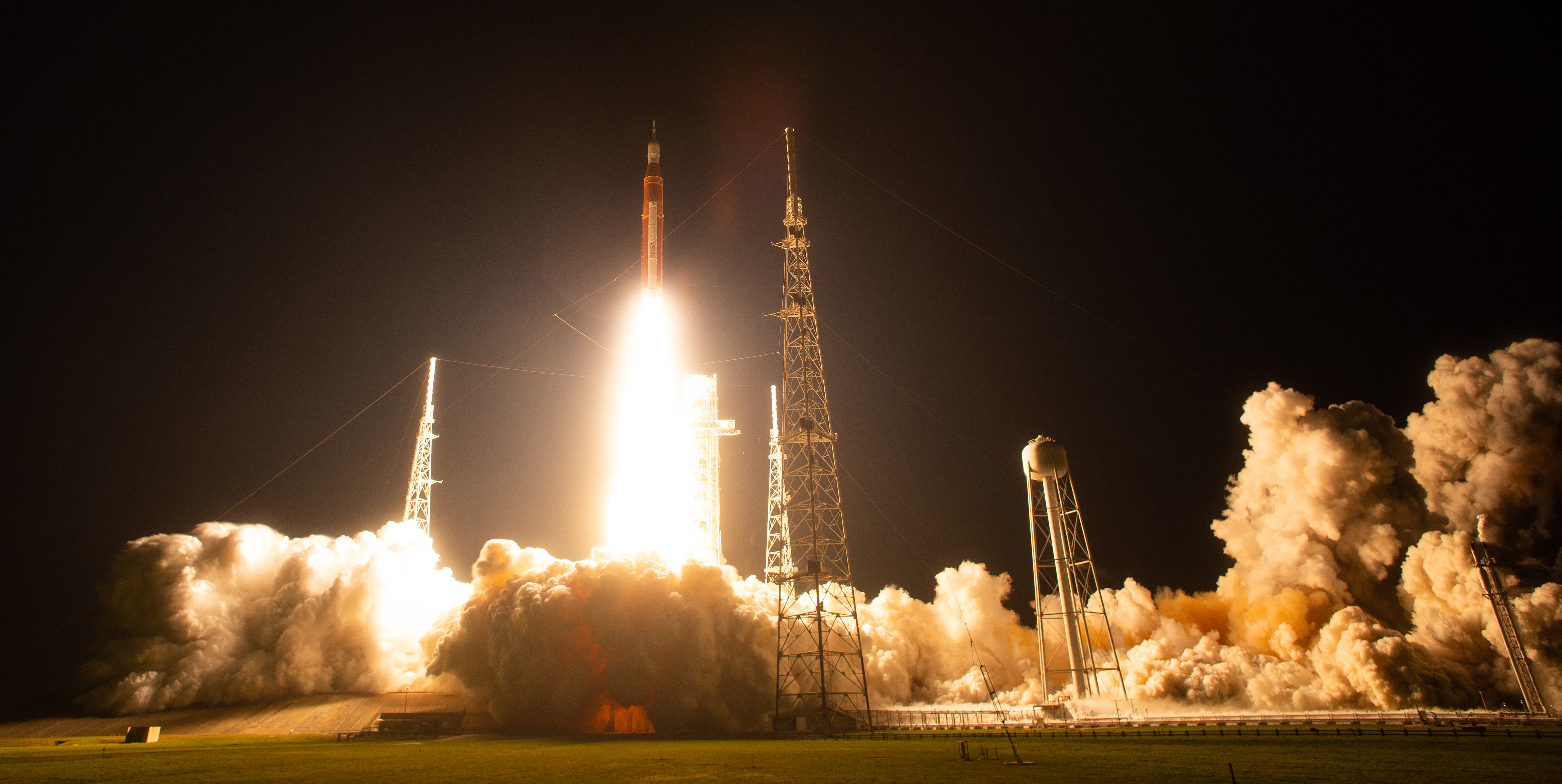 SLS rocket launching at night from Kennedy Space Center during the Artemis I mission, carrying LunaH-Map