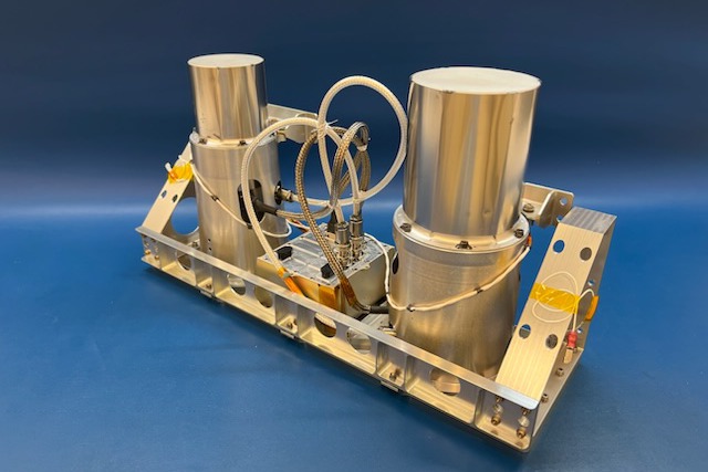 Lunar-VISE GRNS flight unit photographed against a blue backdrop, showing the two sensor heads and control electronics